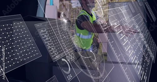 Male warehouse worker responding to tablet prompt, scanning boxes and updating HUD inventory data