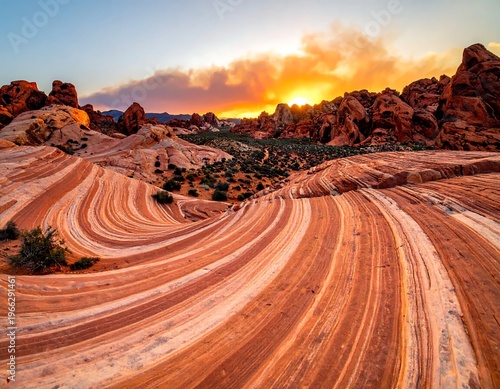 A desert landscape with striped rock formations at sunset