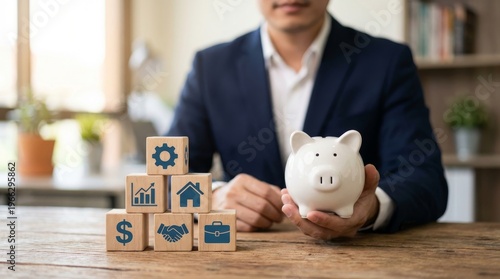 Financial planning, business investment, and savings concept. Man holding piggy bank, wooden blocks with icons.