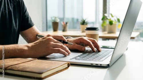 Professional businessman typing on laptop, male hands working on computer, office desk workspace