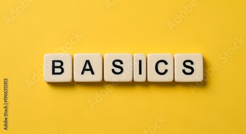 Basics word scrabble tiles yellow background