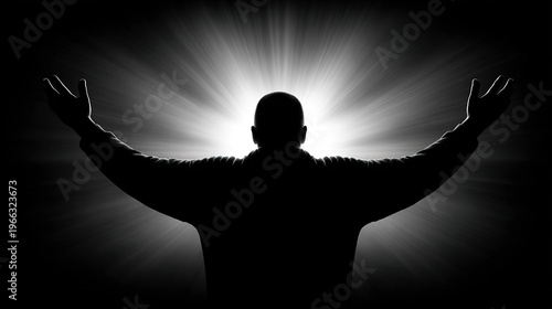 Backlit silhouette of a person with arms raised against bright radiating light