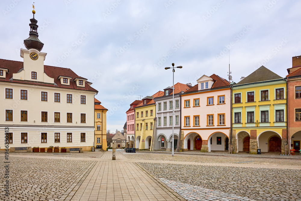 Fototapeta premium Historic town square with colorful buildings under cloudy sky