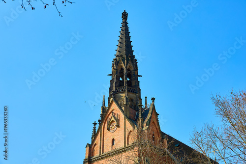 Slika na platnu Gothic revival church spire against clear blue sky