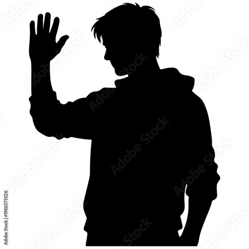 Silhouette of a young man waving hello, facing away from camera