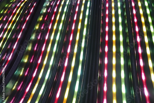 Abstract background of colorful glowing led light strips arranged in parallel vertical lines