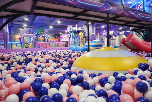 Indoor playground with ball pit and spacethemed decorations