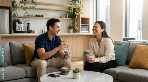 Asian Coworkers Chatting Over Coffee in Modern Office Lounge, Relaxed Workplace Lifestyle