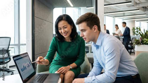 Asian Female Director Mentoring Junior Analyst in Modern Open-Plan Office, Leadership and Career Growth