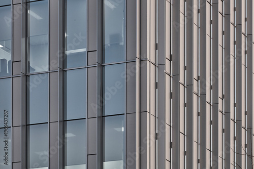 Cuadro en lienzo Close detail of blue glass office tower facade with vertical mullions