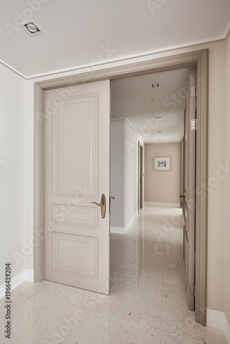 Classic apartment corridor with open panel door and soft light