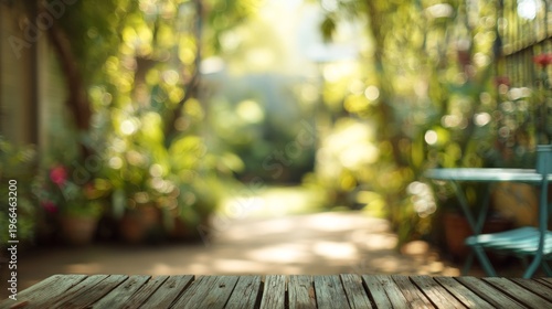 Sunny garden path with bokeh lights with empty wooden table awaits.