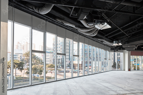 Spacious glass walled commercial hall with city view in bright daylight