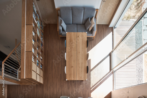 Top view of compact kitchen and stair in warm timber residential interior