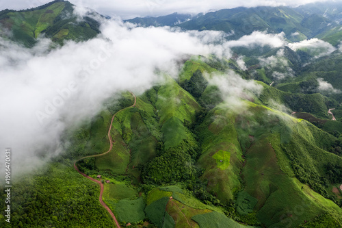 Landscape of Morning Mist with Mountain Layer. mountain ridge and clouds in rural jungle bush forest