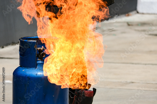 Cuadro en lienzo Close up of tank gas  fire burning from a blue gas cylinder tank concept of gas leak explosion, domestic fire accident, household safety hazard, and fire fighting demonstration or emergency training