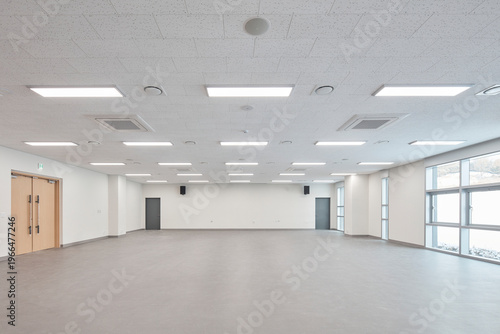 Large empty room with white walls and polished floor in commercial building