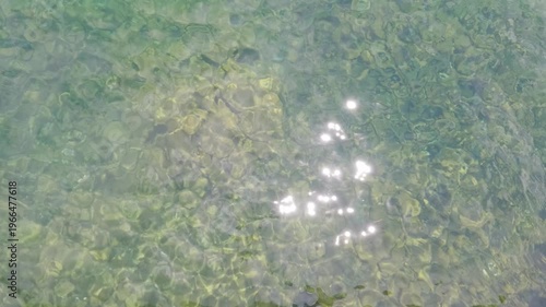 calm lake water wave motion with sunlight reflection for background