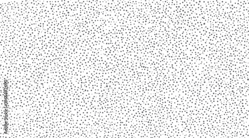 A dense pattern of small and medium sized grey dots scattered across a white background creating a textured effect