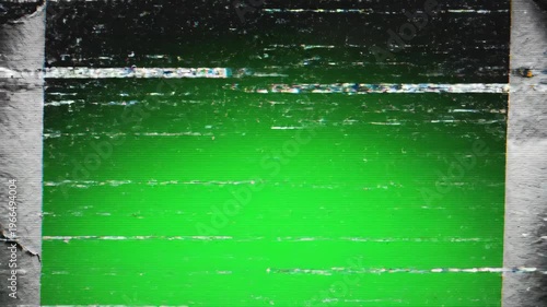 A video shows a dramatic green screen reveal through a torn black background