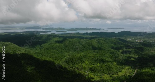 Wallpaper Mural Lush mountain slopes covered in dense forest leading to sea horizon with visible islands. Siargao, Philippines. Torontodigital.ca