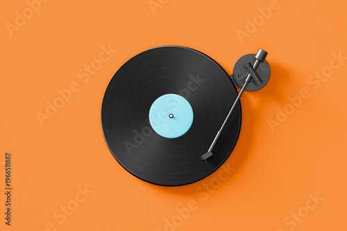 Vinyl record playing on turntable with orange background