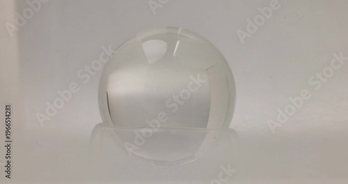 Transparent glass crystal lens ball in heavy smoke move clear fade