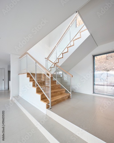 Modern white stair with glass block wall and floating wooden treads