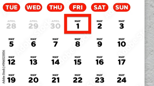 Close-up of the date May 1st marked with a red cursor on the wall calendar 2026