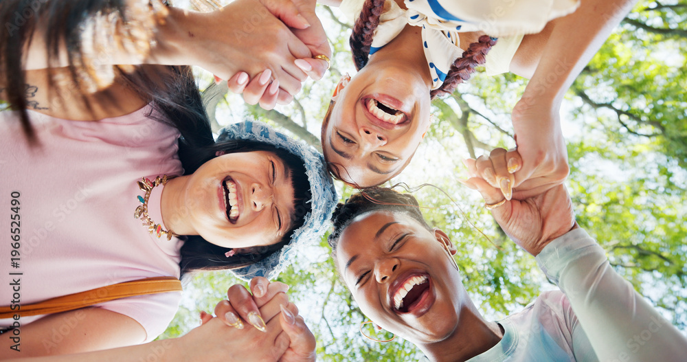 Fototapeta premium Women, portrait and holding hands with friends at park, bonding and laugh together for group reunion. Outdoor, low angle and people with smile for funny joke, friendship and humor in nature and break