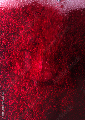 Close-up of red wine bubles in a transparent glass on black backgrond