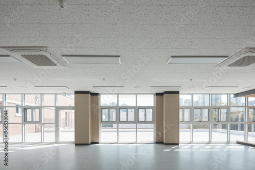 Open classroom or studio with floor to ceiling windows and sunlight