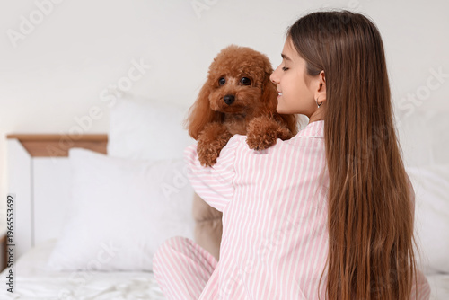 Teenage girl hugging cute T...