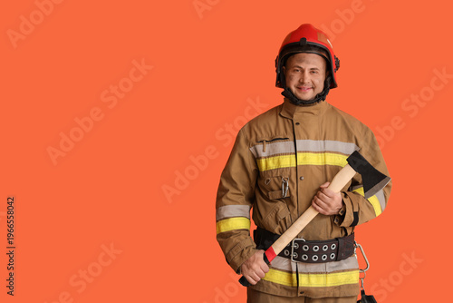 Male firefighter with axe o...