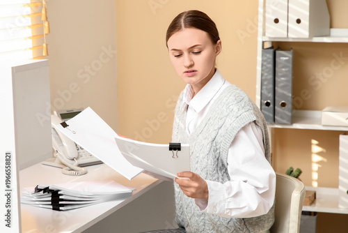 Young businesswoman reviewi...