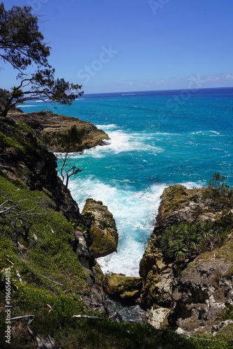 Rocky coastal cliffs and turquoise ocean waves at North Stradbroke Island Queensland Australia