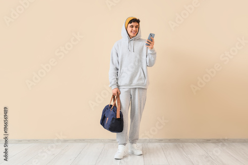 Young man in grey sports su...