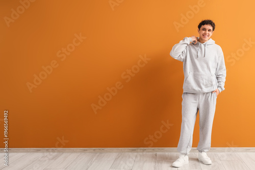 Young man in grey sports su...
