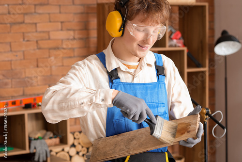 Young carpenter staining wo...