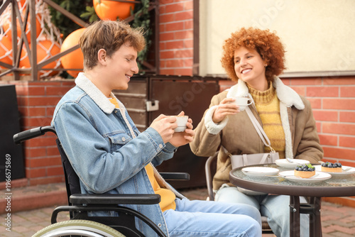Young man in wheelchair wit...