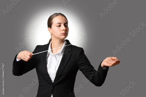 Female conductor on dark ba...