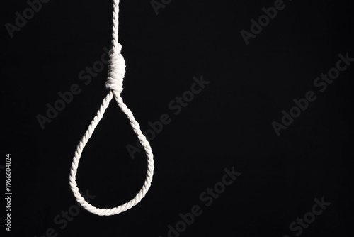 Hanging rope with loop on dark background. Suicide concept