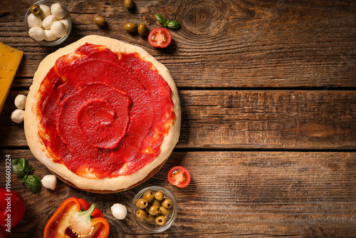 Pizza dough with tasty toma...
