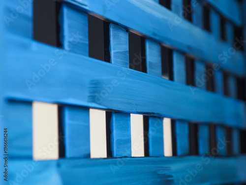 Abstract close-up of a blue wooden partition with elegant vertical lines. A versatile backdrop providing ample copy space for creative branding and lifestyle storytelling.