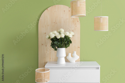 Vase with white roses on ch...