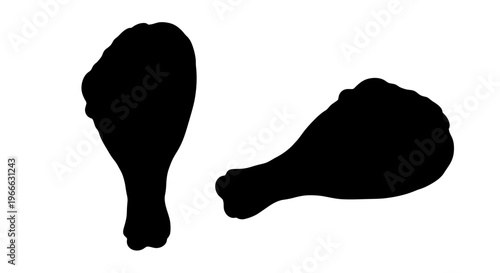 Two pieces of fried chicken shown in stark black silhouette