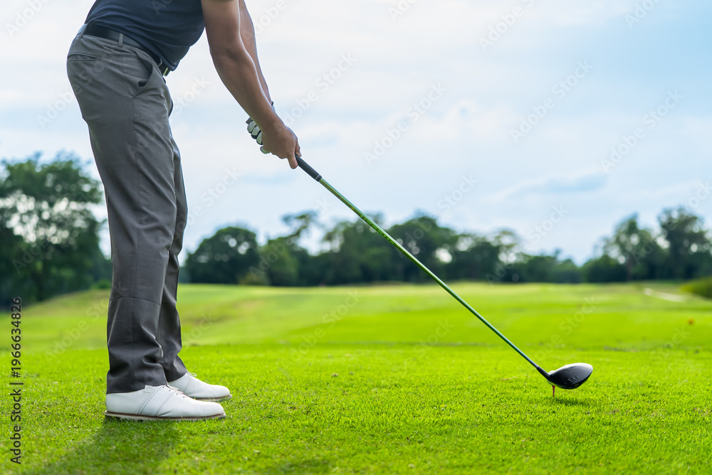 Fototapeta premium Close up of professional golfer swinging club on a scenic golf course. 