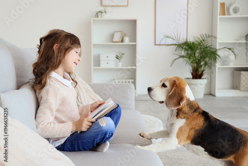 Cute little girl with Beagl...