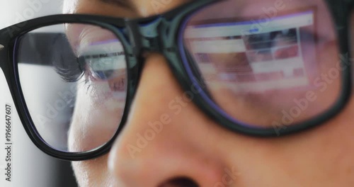 Business beautiful young woman in glasses close-up in which the computer monitor is reflected