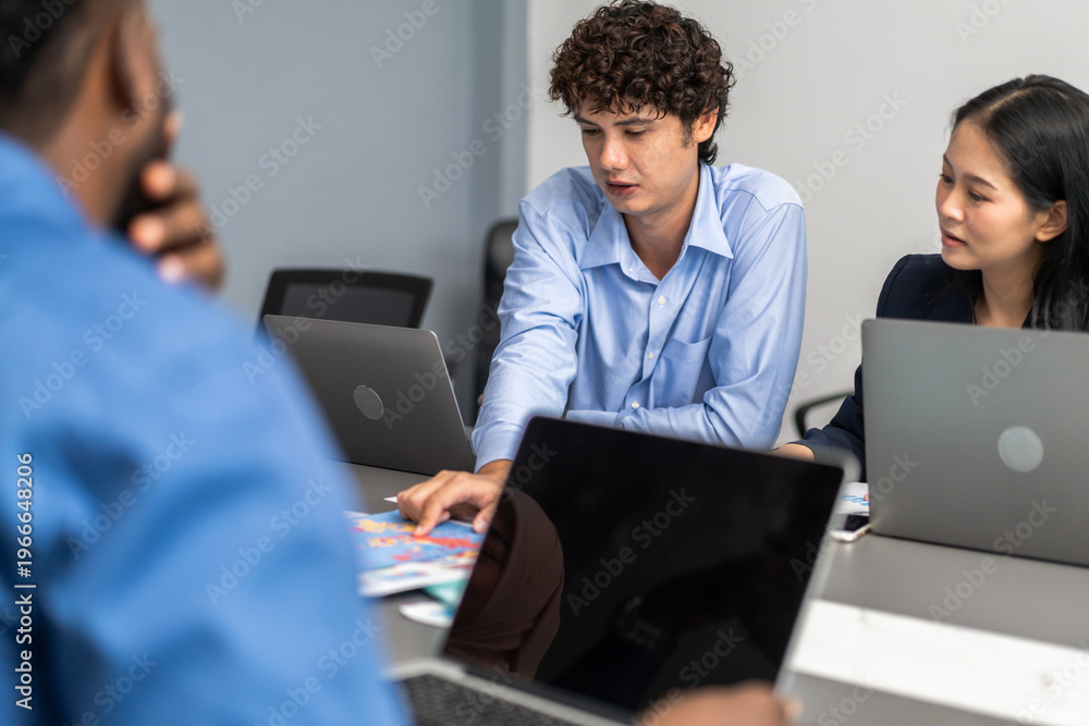 Obraz premium Diverse IT consulting team discussing software integration at office desk, B2B technology solution, SaaS product development, digital transformation workflow and corporate data management concept
